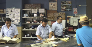 Peruvian countermen look up parts at Motorama, a local family-owned auto parts store visited by the trade delegation.
